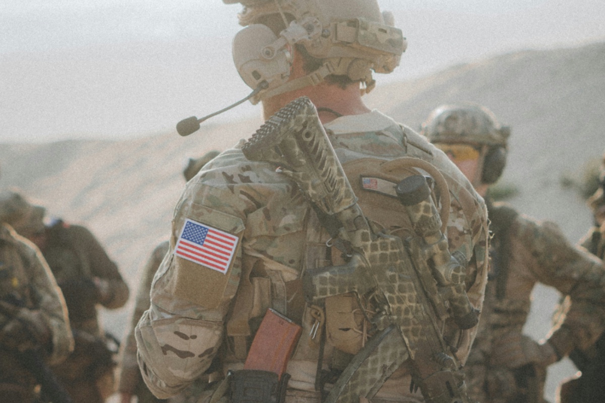 Service members in field gear standing in formation during a training exercise.